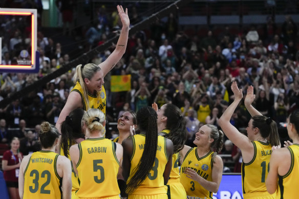 Lauren Jackson is held aloft by teammates.