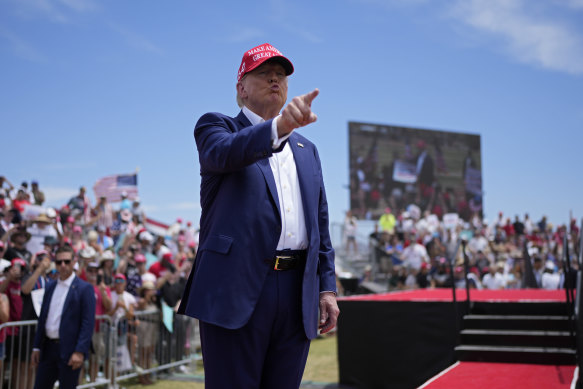 Former president Donald Trump motions to the crowd at a campaign rally in Las Vegas on Sunday.