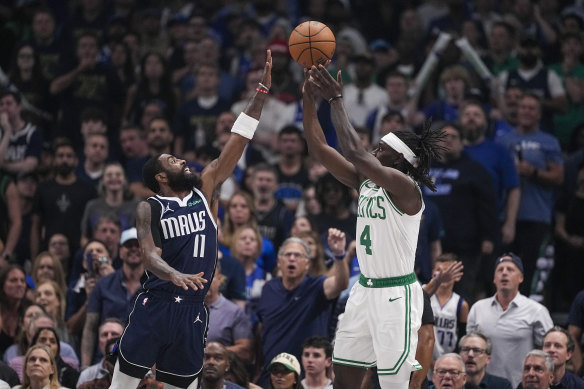 Boston Celtics guard Jrue Holiday (4) shoots against Dallas Mavericks guard Kyrie Irving (11).