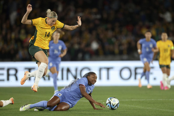 Australia’s Alanna Kennedy, top, jumps over France’s Kadidiatou Diani.
