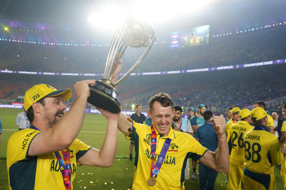 Marnus Labuschagne (centre) lifts the World Cup trophy with Travis Head after their match-defining partnership secured Australia’s win.