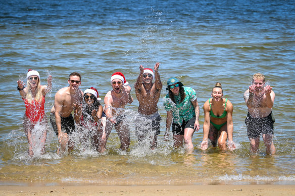 Richard Burgess, fourth from left, and friends at St Kilda Beach on Christmas Day.