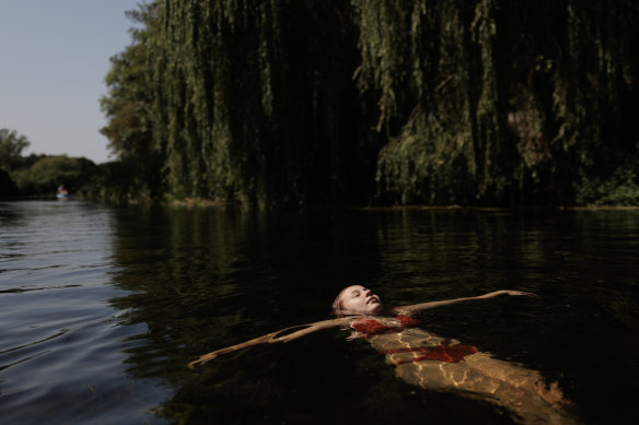 A girl floating in the River Stour in Britain in August.