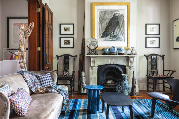 Victorian-era details, such as a coffered ceiling and a marble mantelpiece, feature in one of the home’s two front living rooms. The main artwork, Raven, is by Jim Dine.