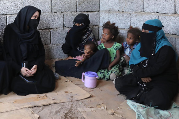 Angelina Jolie, left, meets displaced Yemeni people, who fled their homes during the war, at a makeshift camp in Aden, Lahej, Yemen, in March.