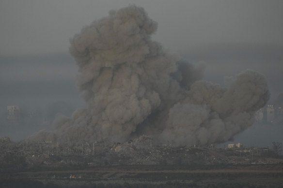 Smoke rises following an Israeli airstrike in the Gaza Strip, moments before the start of the temporary ceasefire.