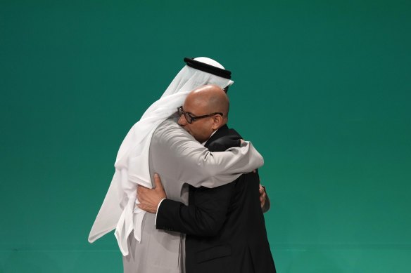 United Nations Climate Chief Simon Stiell (right) and COP28 President Sultan al-Jaber embrace at the COP28 