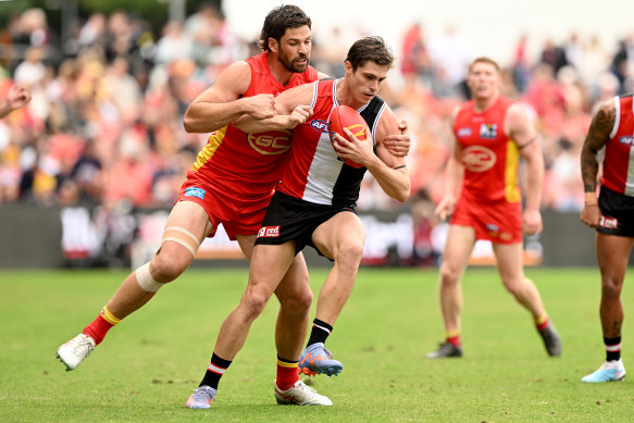 Gold Coast’s Levi Casboult swarms on Jack Steele of the Saints.