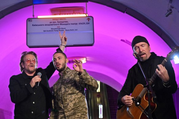 Irish singer-songwriter Bono with Taras Topolia, a Ukrainian band leader and now a serviceman in the Ukrainian Army, and guitarist The Edge perform at a metro station in Kyiv.