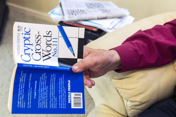 Donald Harrison with one of the many crossword books he has written for Puzzle People.