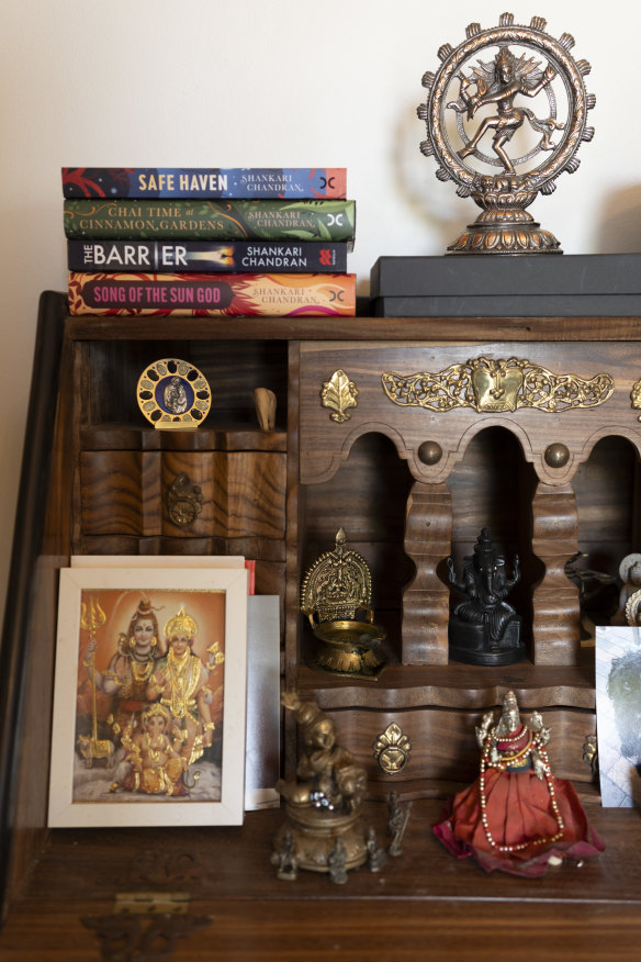 Some of Chandran’s novels atop a Hindu shrine at home.