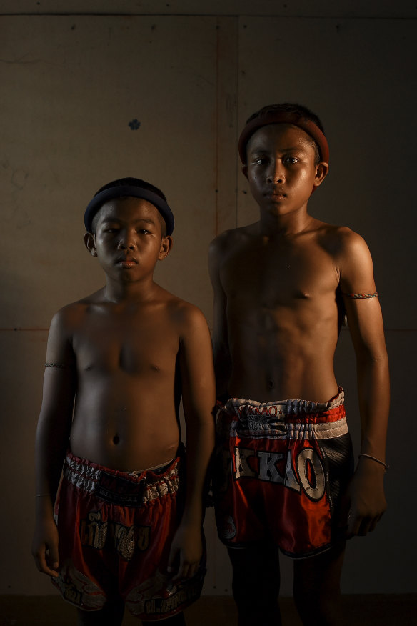 Muay Thai fighters Samsun, 11, and Ek Phuton, 12, wearing the traditional Muay Thai headband called a Mongkon.