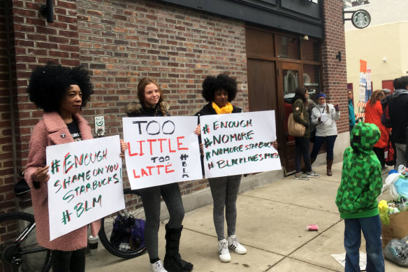 Protesters gather outside a Starbucks in Philadelphia on Sunday, where two black men were arrested.