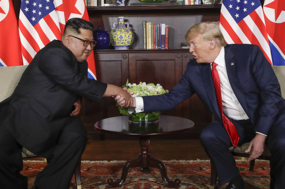North Korea leader Kim Jong-un, left, and US President Donald Trump shake hands during their first meeting at the Capella resort on Sentosa Island in Singapore.