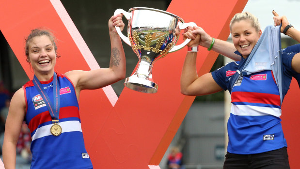 Ellie Blackburn (left) and Katie Brennan (who didn't play) with the premiership cup.