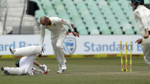 Charged by referee: Nathan Lyon drops the ball in the direction of de Villiers.