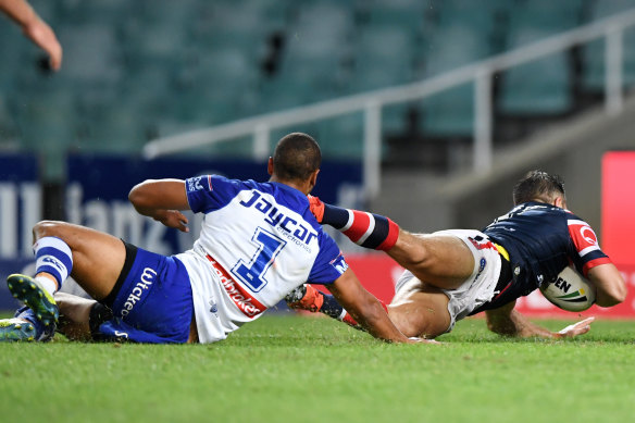 Four more: Moses Mbye fails to prevent a Roosters try.