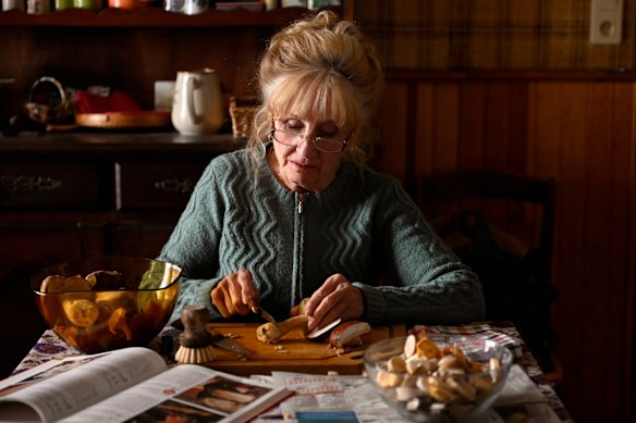 Michelle (Helene Vincent) chops foraged mushrooms for a family lunch in When Fall Is Coming. 