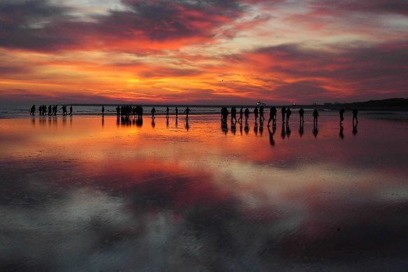 Migrants wait on the beach for a dinghy in Gravelines, France. The numbers of migrants crossing the English Channel in small boats is up roughly 40% on last year. It was reported in April that the UK and France are holding negotiations over a potential deal to return irregular migrants who cross the English Channel in small boats. 