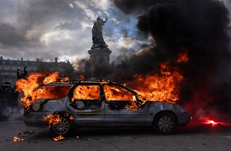 A car is set ablaze during demonstrations in Paris.