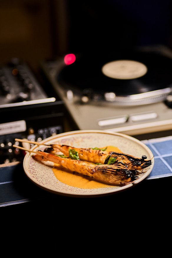 Charred prawns with prawn bisque and fried basil. 