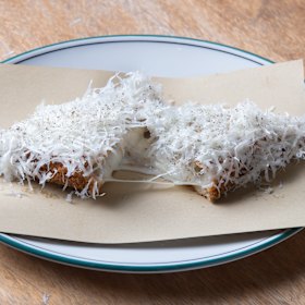 Hardware Club’s cacio e pepe jaffle filled with taleggio and pepper and showered in grated pecorino.
