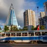 A tram passes in front of the pyramid-shaped Ryugyong Hotel in Pyongyang.