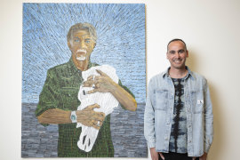 Former refugee Mostafa Azimitabar with his portrait of Angus McDonald, which is a finalist in the Archibald Prize at the Art Gallery of NSW.