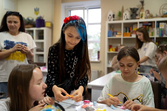 Ten-year-old Masha (centre) finds joy and learning at a child-friendly space in Kharkiv.