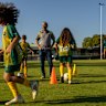 Sylvania Heights Football Club coach Aiman Gouda, pictured alongside young members of the grassroots club.