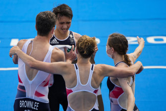 Great Britain’s Alex Yee is congratulated by his teammates after bringing home the bacon in the mixed triathlon relay.