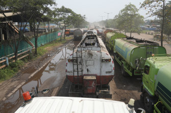 Trucks to transport crude palm oil queue outside a factory at Marunda in Jakarta’s north.