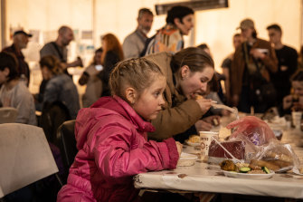 Escapees from Mariupol’s steel plant eat a warm meal in the reception tent in Zaporizhzhia.