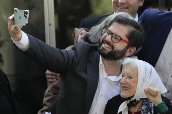 Chile’s President Gabriel Boric poses for a picture with member of Mothers of Plaza de Mayo, on a visit to Buenos Aires, Argentina.