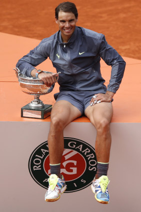 Rafa's dozen: Nadal poses with the French Open trophy after beating Dominic Thiem in the final.