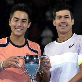 Rinky Hijikata and Jason Kubler pose with their Australian Open trophy.