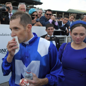 Jockey Hugh Bowman (with wife Christine) nurses a split lip after Winx headbutted him after riding to victory in the Longines Queen Elizabeth Stakes during The Championships Race Day at the Royal Randwick Racecourse. 
