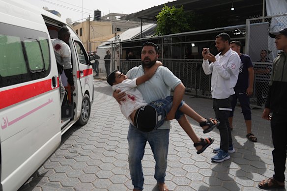 A Palestinian youth injured in an Israeli airstrike is brought to Al-Aqsa Hospital.