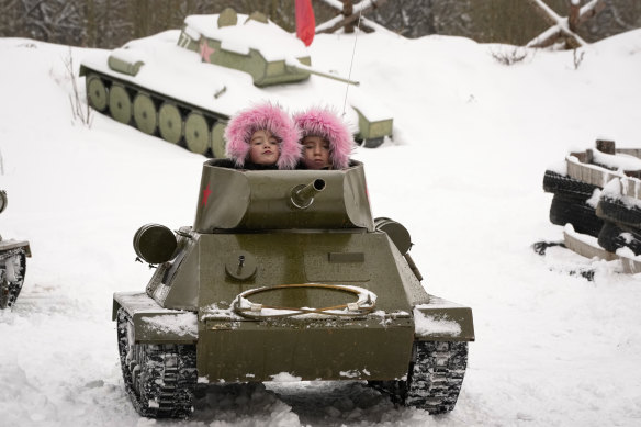 History forever: Children ride a model of World War II-era Soviet T-34 tank during a military historical festival outside St Petersburg, Russia in February.