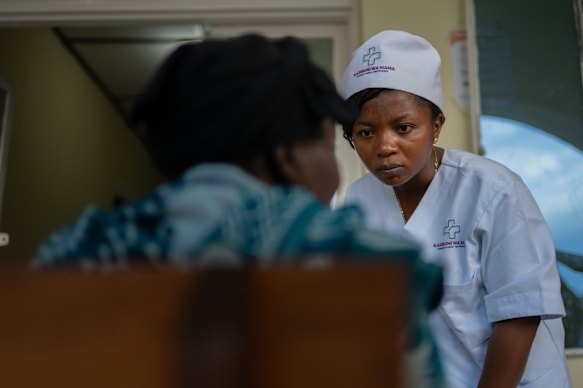 Dr Elizabeth Furaha speaks with a relative of a patient at Sofepadi Hospital in Bunia, Congo, on Friday. The Democratic Republic of Congo has more than 1000 confirmed Ebola cases.