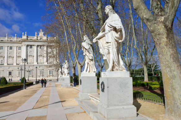 Madrid’s Plaza de Oriente with  statues and Royal Palace.