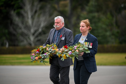Veteran Phil Neil and LGBTQ advocate and serving navy member Rachael Cosgrove lay wreaths at the Shrine on Sunday.
