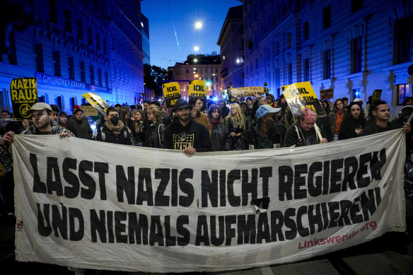 Anti right-wing protesters shout slogans holding a banner that reads “Don’t let Nazis rule and never let them march” near the parliament building in Vienna, Austria.