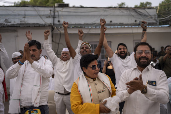 Congress party supporters cheer as they follow proceedings of vote counting at their party headquarters in New Delhi, India.