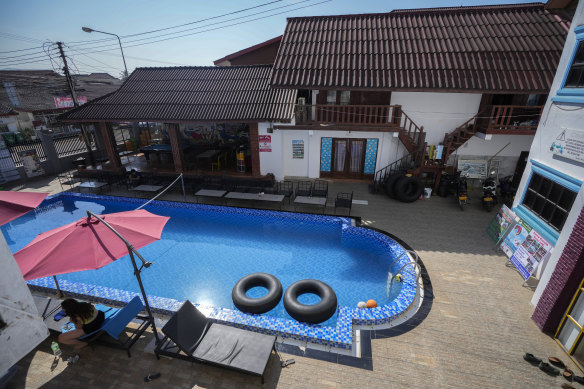 A backpacker rests near the swimming pool at Nana’s on Friday. 