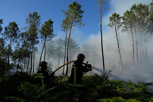 Firefighters work to suppress a blaze near Lacanau, France, on Monday.