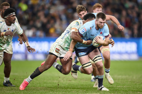 Jed Holloway takes the ball forward with defenders hanging from him.