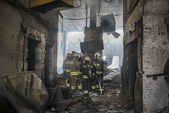 Firefighters work at the scene of the hotel.
