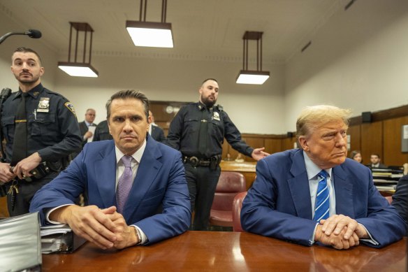 Former president Donald Trump and lawyer Todd Blanche await the start of proceedings on the second day of jury selection.