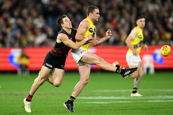 Essendon skipper Zach Merrett tackles Tiger Jack Ross in this year’s Dreamtime at the ’G game.